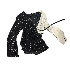 Black and white polka dot low cut long sleeve blouse. Ties in front